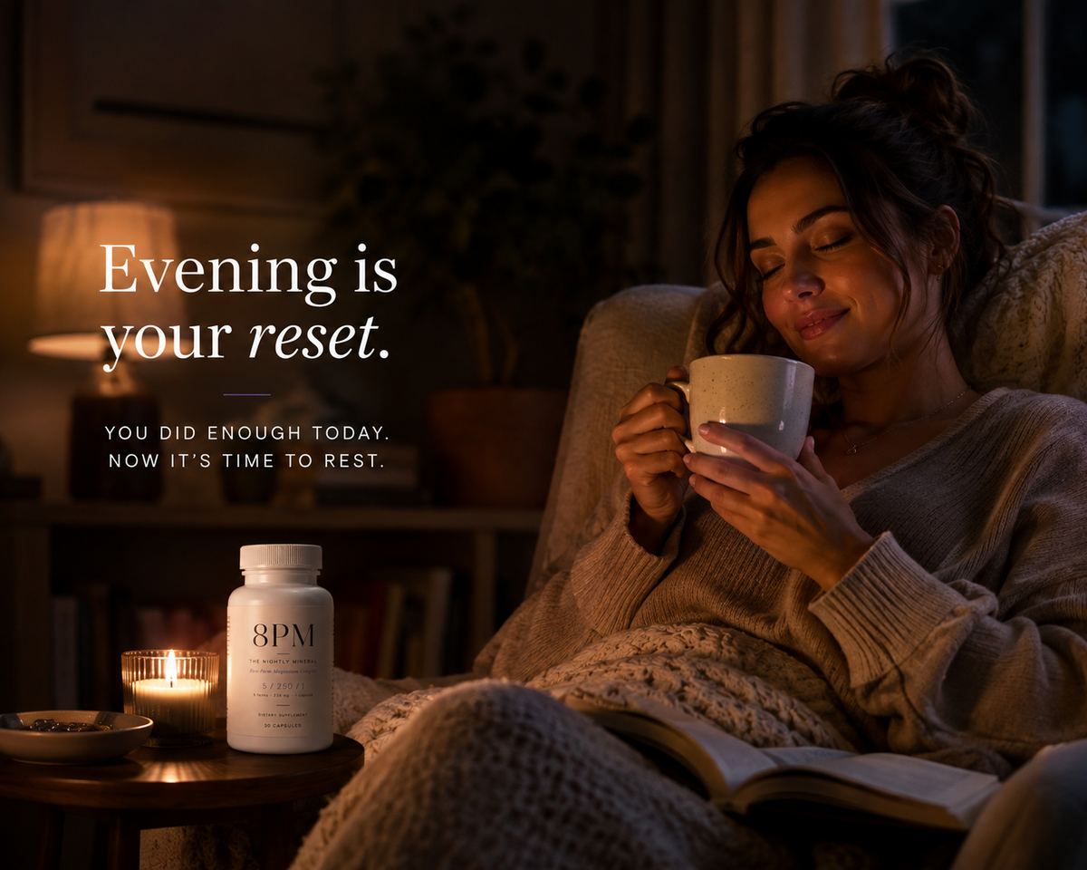Woman relaxing on a sofa at candlelight with an 8PM bottle and a mug